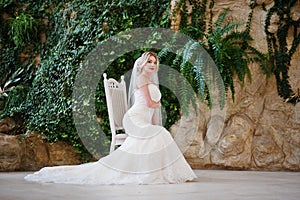 Gorgeous blonde bride with long veil