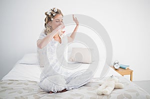 Gorgeous blonde yawning on cosy bed