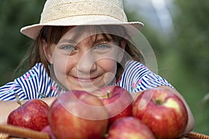 Gorgeous Blue Eyed Girl in a Straw Hat With A Basket of Red Apples