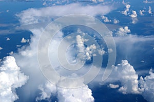 Gorgeous blue skies with heavy cloud cover seen from jet window seat