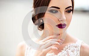 Gorgeous bride with fashion makeup and hairstyle in a luxury wedding dress