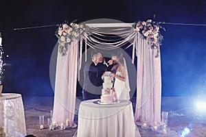 Gorgeous bride and stylish groom tasting their stylish wedding cake