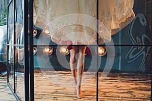 Gorgeous, bride in white luxury dress is getting ready for wedding. Morning preparations. Woman putting on dress.