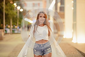 gorgeous brunette girl portrait in night city lights.