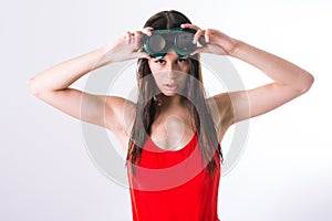 Gorgeous brunette lady wearing a red swimsuit and holding some goggles