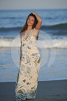Gorgeous brunette woman in dress at beach