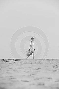 Gorgeous brunette woman in dress walking in the desert sand