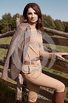 Gorgeous brunette woman in an elegant checkered brown jacket