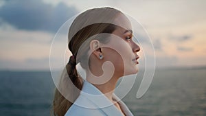 Gorgeous businesswoman admiring sea sunset standing shore closeup. Woman looking