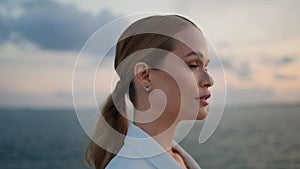 Gorgeous businesswoman admiring sea sunset standing shore closeup. Woman looking