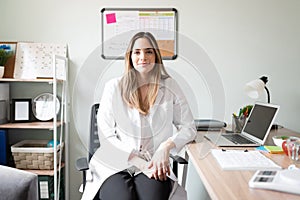 Pretty dietician sitting at her office photo