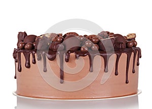 Gorgeous chocolate cake decorated with chocolates and cookies isolated on white