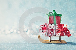 Gorgeous christmas presents on Santas sleigh. Miniature Christmas winter wonderland. Xmas greeting card. photo