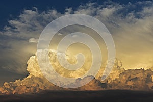 Gorgeous close up view of fluffy cumulus clouds/ Yellow and white clouds during sunset/ Above the clouds/ Sky background