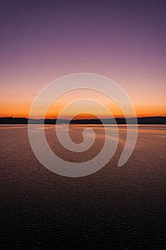 A gorgeous color and contrast over the lake at sunset. Vertical frame.