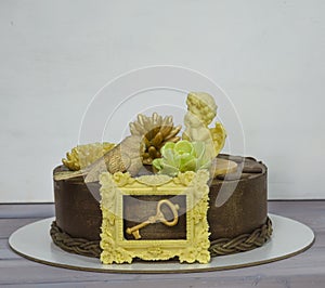 Gorgeous extra chocolate cake with succulents and an angel