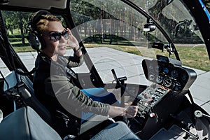 Gorgeous female helicopter pilot being about to start flight photo