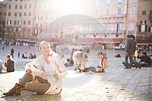 Gorgeous female tourist with a map discovering a foreign city