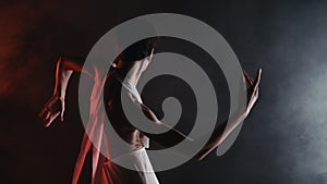 Gorgeous flexible woman with bare back performing amazing modern choreography - elegant contemporary style dance in dark