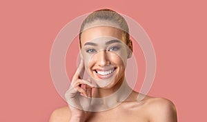 Gorgeous Girl Posing Touching Face Smiling At Camera, Studio Shot