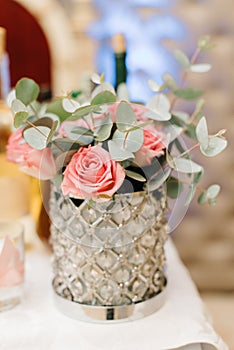 Gorgeous glass vase holds pink pastel roses