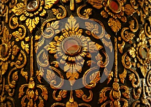 Gorgeous Gold and Black Vintage Thai Pattern on the Teak Lacquered Pillar in Wat Phumin Temple, Nan Province, Thailand