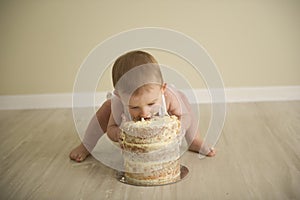 Gorgeous happy blue eyed baby boy in neutral tones turns one