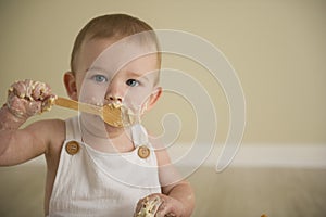 Gorgeous happy blue eyed baby boy in neutral tones turns one