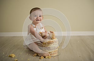 Gorgeous happy blue eyed baby boy in neutral tones turns one