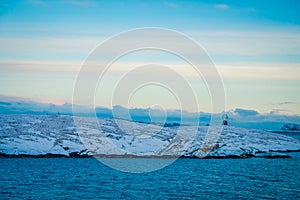 Gorgeous landscape of coastal scenes ofcoast covered with snow on Hurtigruten during voyage in a good weather