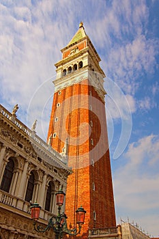 Gorgeous landscape view of medieval St. Mark`s Campanile bell tower of St. Mark`s Basilica against sunny autumn sky