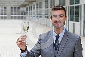 Gorgeous male cheering with a glass of champagne