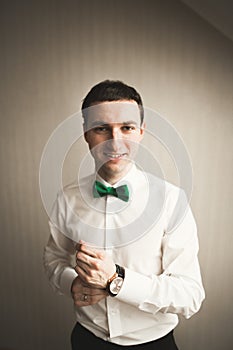 Gorgeous man, groom prepares for wedding ceremony in luxury hotel