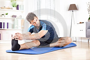 Gorgeous Man Performing Hamstring Stretch at Home