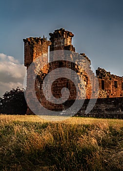 Gorgeous moody shot of the corner portion and surrounding wall of Penrith Castle at sunset in Cumbria, England