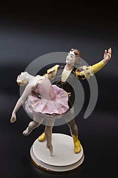 Gorgeous old figurine of a ballerina and her partner performing the adagio (slow part of the dance).