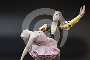 Gorgeous old figurine of a ballerina and her partner performing the adagio (slow part of the dance).