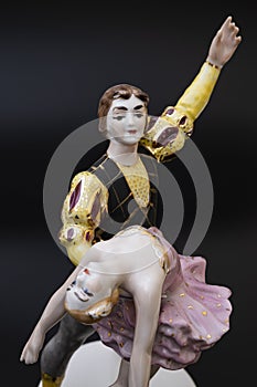 Gorgeous old figurine of a ballerina and her partner performing the adagio (slow part of the dance).