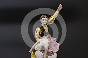 Gorgeous old figurine of a ballerina and her partner performing the adagio (slow part of the dance).