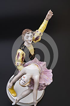 Gorgeous old figurine of a ballerina and her partner performing the adagio (slow part of the dance).