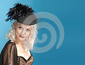 Gorgeous retro girl in forties hat with feathers