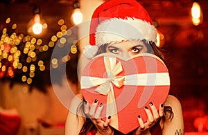 Gorgeous Santa girl. Stunning beauty. Christmas decorations. Festive mood. Woman attractive playful lady celebrate
