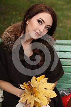 Gorgeous sensual woman with dark hair in elegant clothes and luxurious coat,