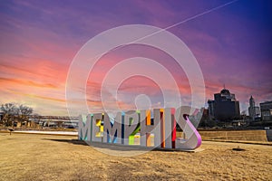 A gorgeous shot of the colorful Memphis sign with gorgeous blue sky and powerful clouds at sunset with yellow winter grass