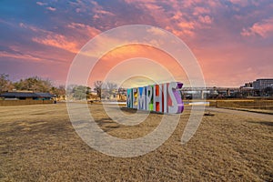 A gorgeous shot of the colorful Memphis sign with gorgeous blue sky and powerful clouds at sunset with yellow winter grass