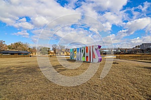 A gorgeous shot of the colorful Memphis sign with gorgeous blue sky and powerful clouds with yellow winter grass and skyscrapers