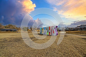 A gorgeous shot of the colorful Memphis sign with gorgeous blue sky and powerful clouds with yellow winter grass and skyscrapers