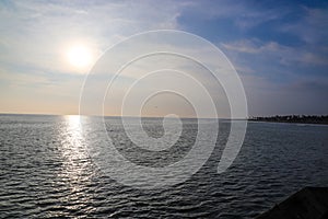 A gorgeous shot of vast blue rippling ocean water at sunset with blue sky and clouds at sunset at Surfers Point at Seaside Park