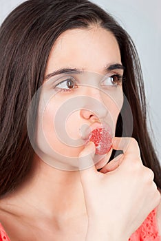 Gorgeous slender girl seductively eating candy