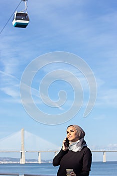 Gorgeous smiling Arabic woman with mobile phone